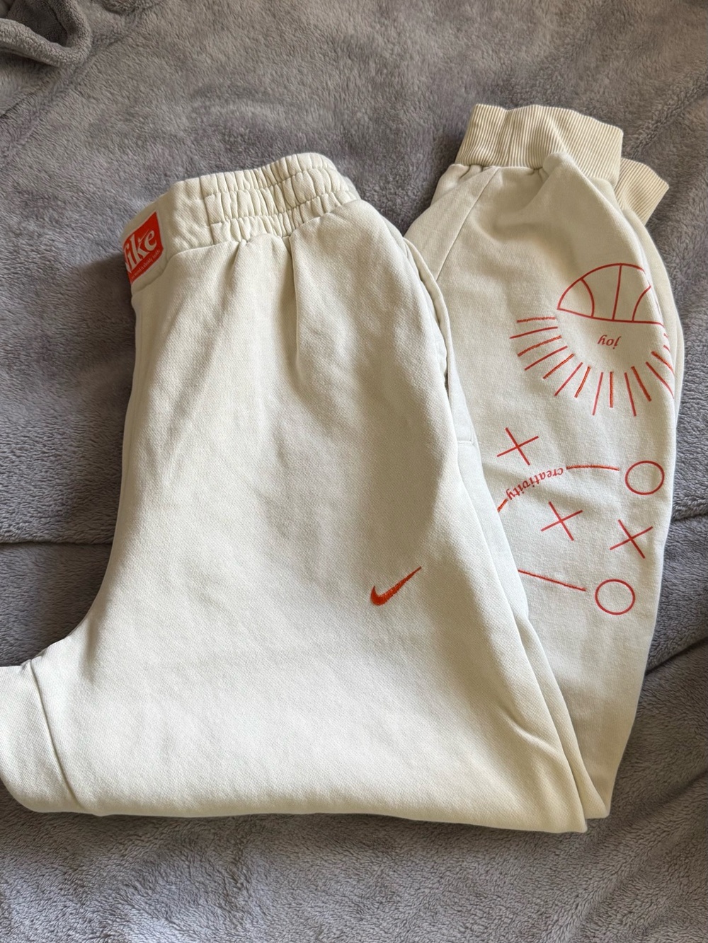 Nike Kids Cream Joggers with Orange Swoosh & Graphic